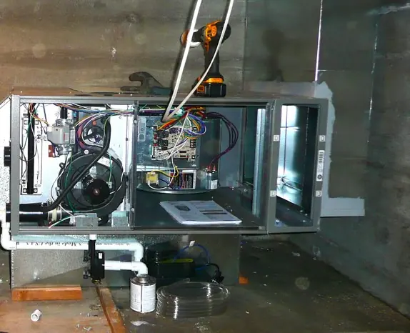 Horizontal furnace with its front panel off, showing the inducer, wiring and control board