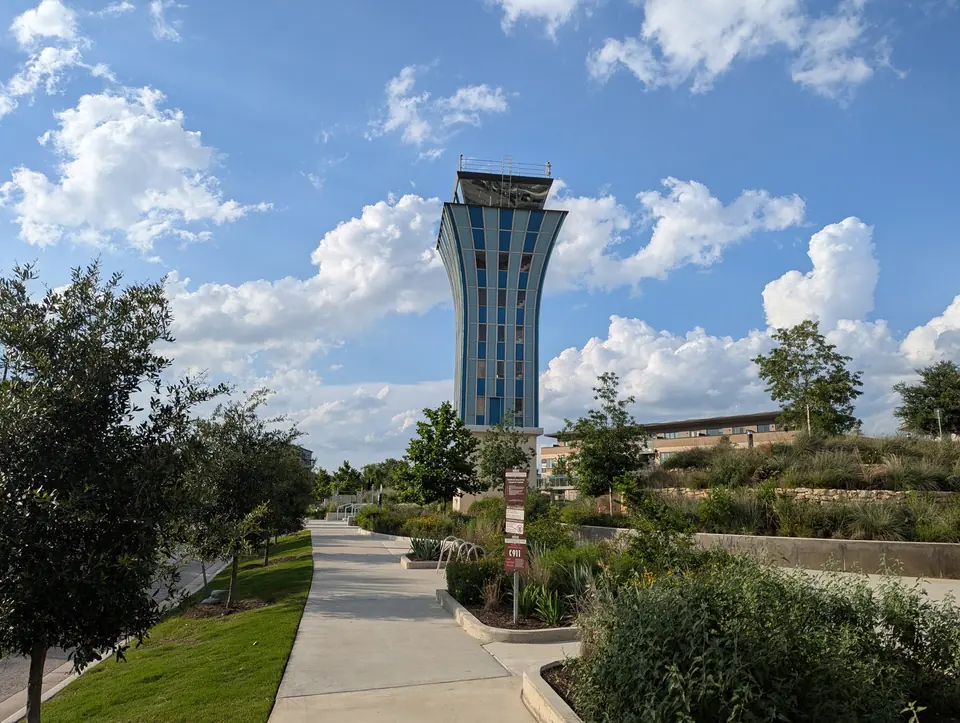 The old Mueller airport control tower beside a park path in Mueller, Austin